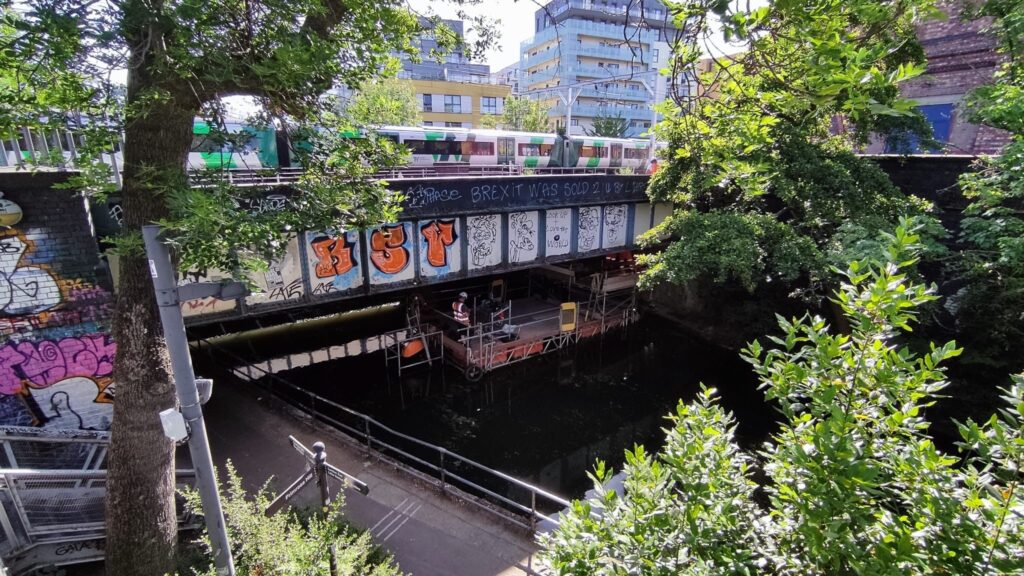 ScaffFloat with cantilever access shelf under a railway bridge in Camden